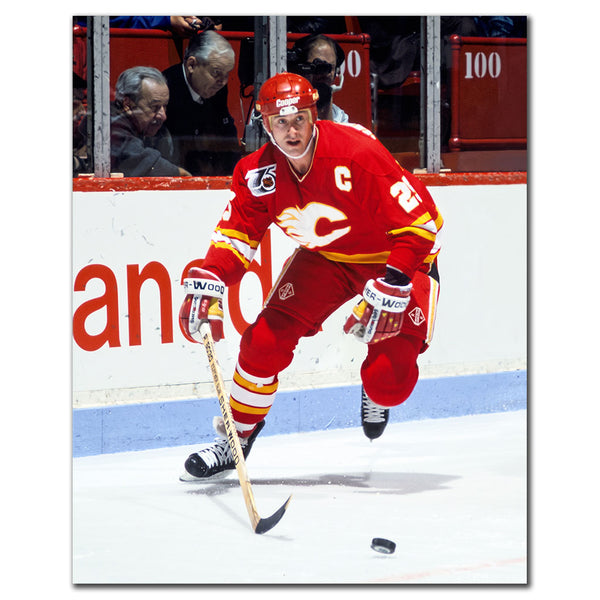 Joe Nieuwendyk in a Calgary Flames red jersey skating with the puck