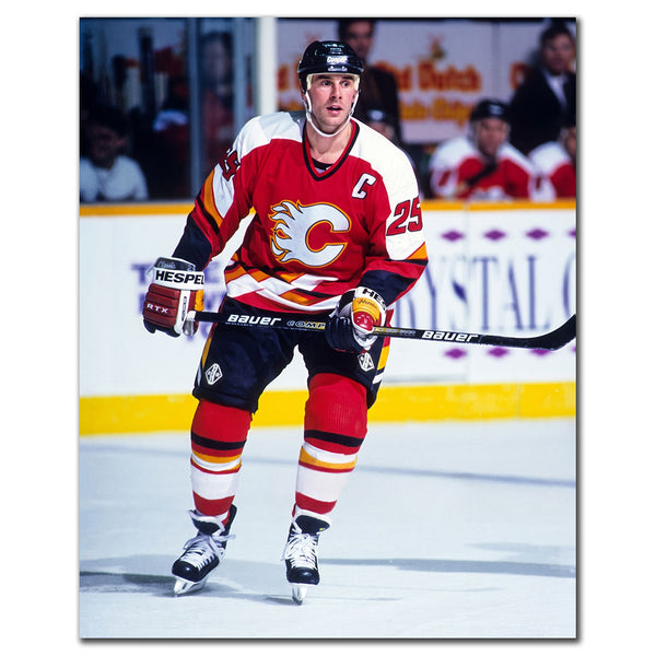 Joe Nieuwendyk wearing a Calgary Flames red jersey standing on the ice