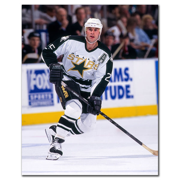 Joe Nieuwendyk wearing a Dallas Stars white jersey skating during a game