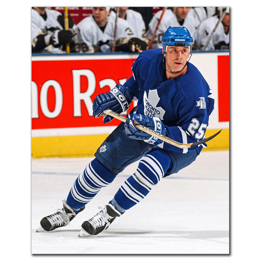 Joe Nieuwendyk wearing a Toronto Maple Leafs white jersey skating during a game