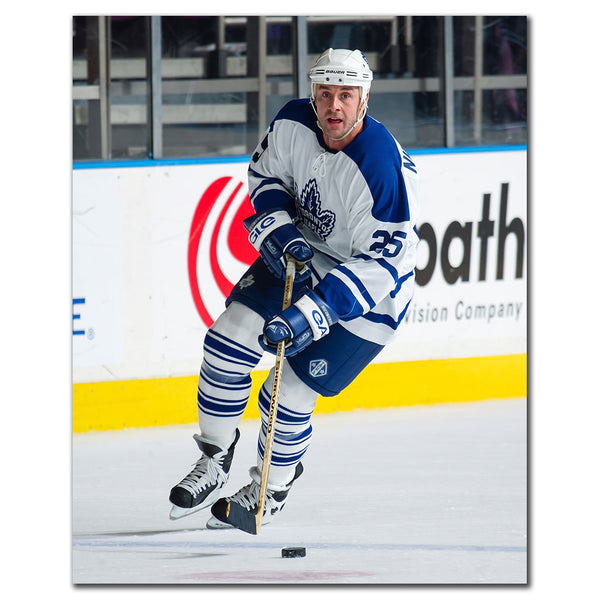 Joe Nieuwendyk wearing a Toronto Maple Leafs white jersey skating during a game
