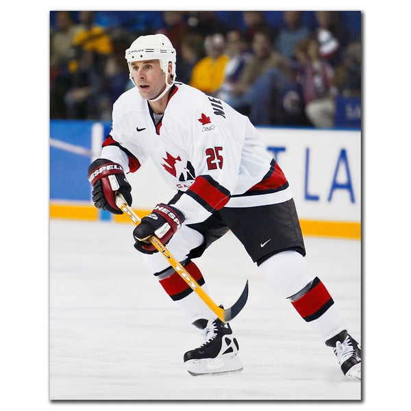 Joe Nieuwendyk wearing a white Team Canada jersey while skating during a game