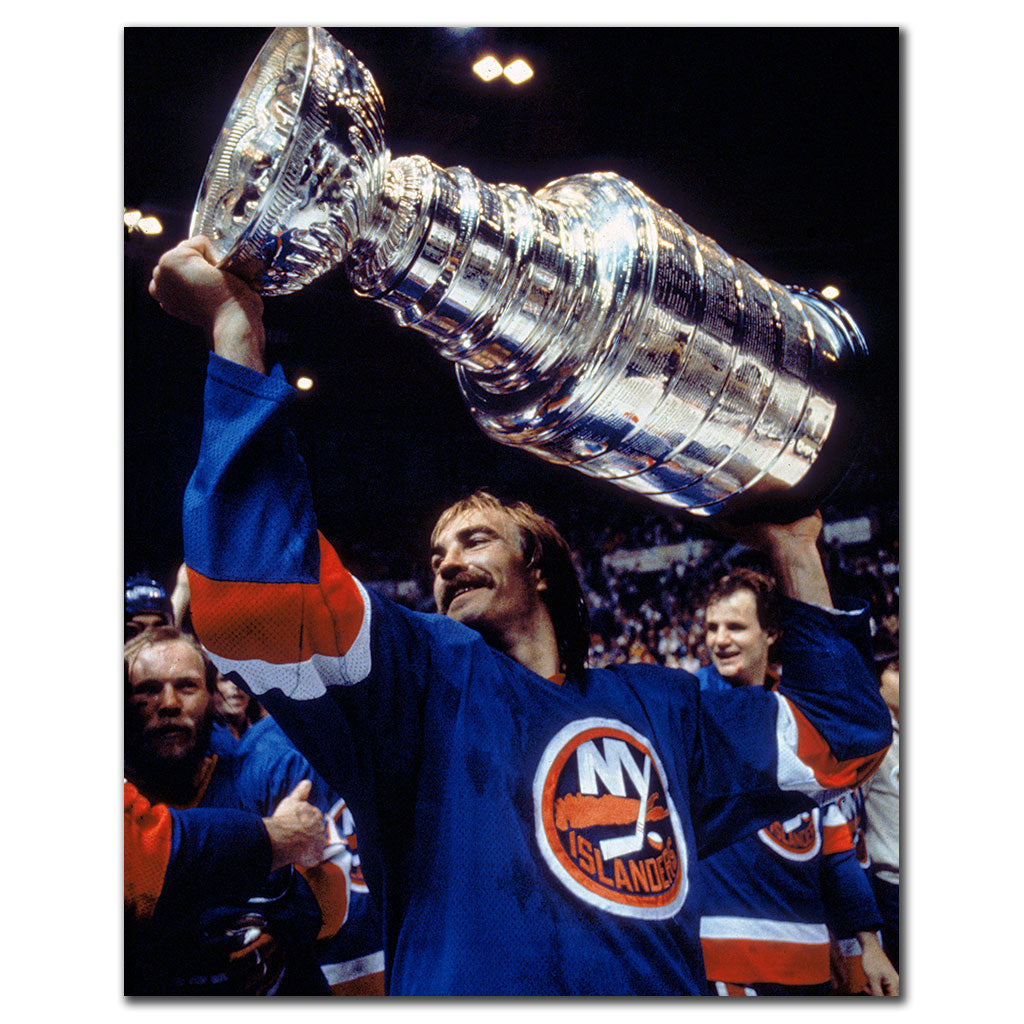Bob Nystrom celebrating with the Stanley Cup in a New York Islanders uniform