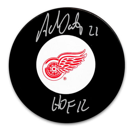 Adam Oates Detroit Red Wings HOF signed hockey puck, featuring a clear autograph—perfect collectible for sports enthusiasts.