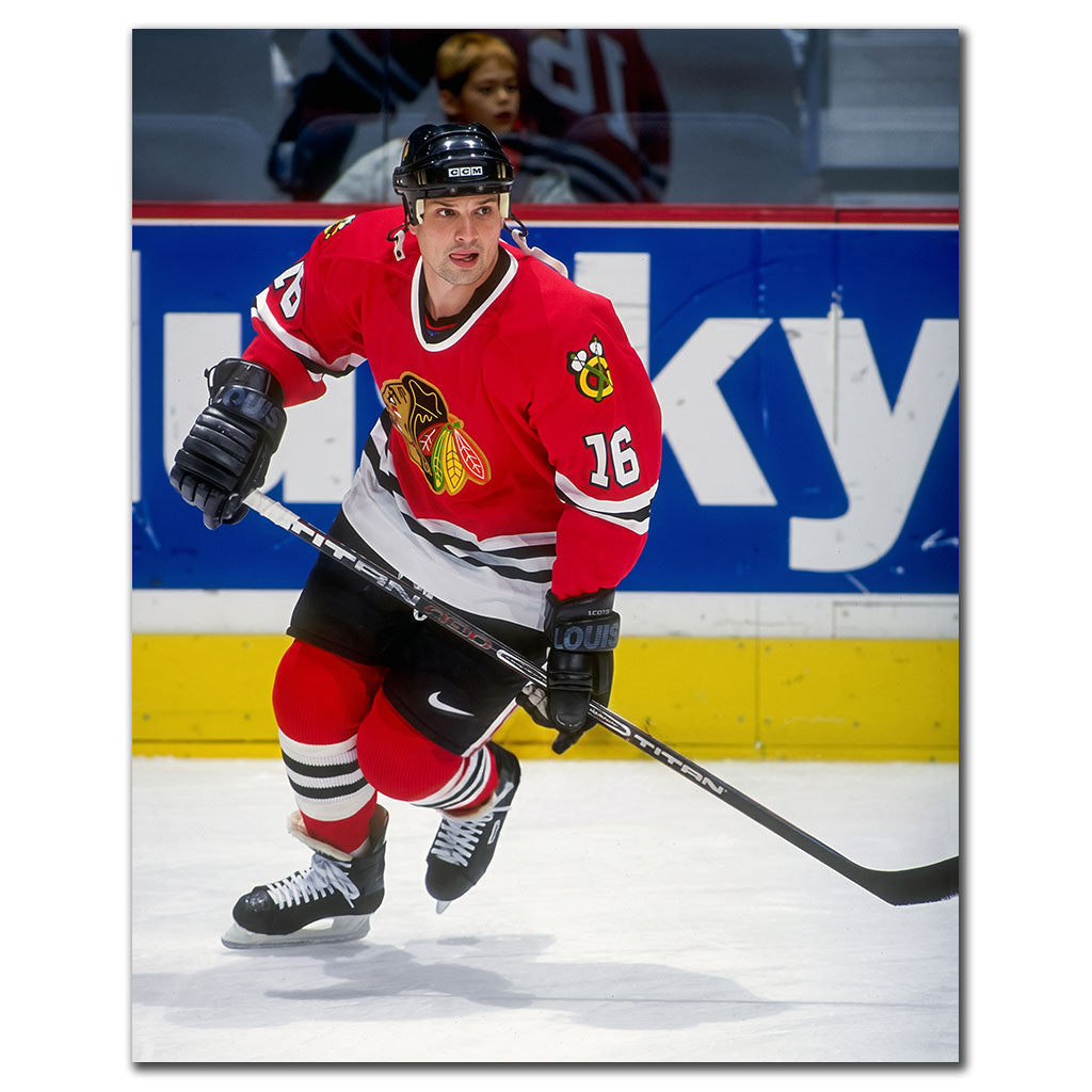 Ed Olczyk skating in a red Chicago Blackhawks jersey during an NHL game
