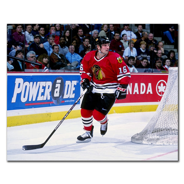 Ed Olczyk skating behind the net in a red Chicago Blackhawks jersey during an NHL game