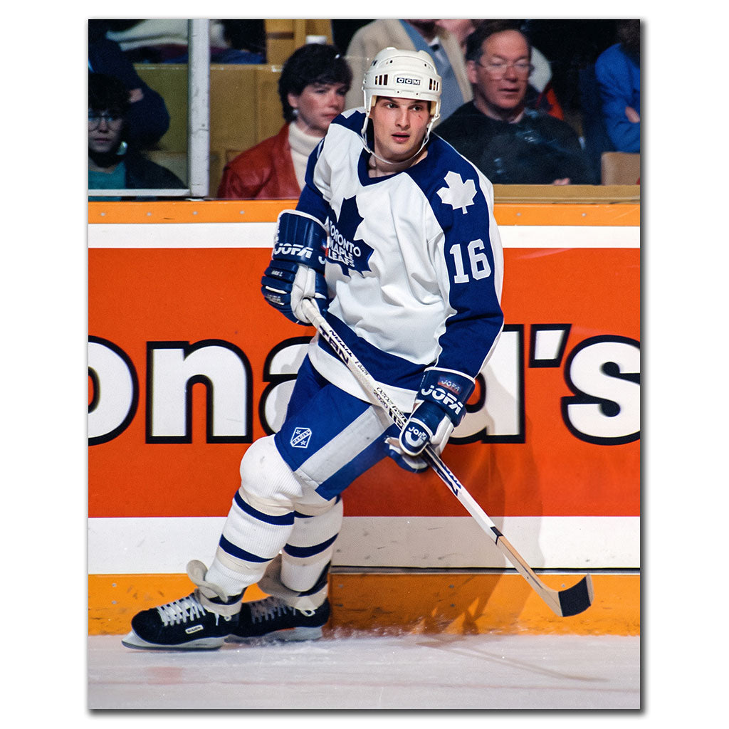 Ed Olczyk skating near the boards in a white Toronto Maple Leafs jersey