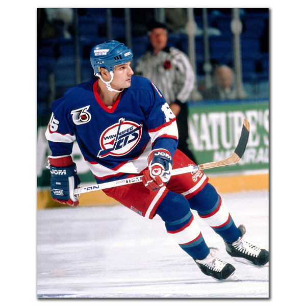 Ed Olczyk skating in a blue Winnipeg Jets jersey with a 75th anniversary patch