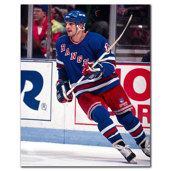 Ed Olczyk skating in a blue New York Rangers jersey during an NHL game