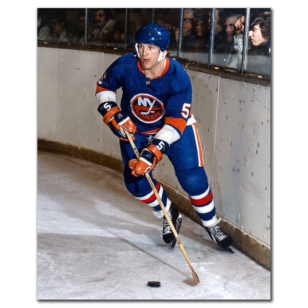Denis Potvin New York Islanders 8x10 hockey photo in a blue uniform controlling the puck while skating along the boards for autograph pre-order