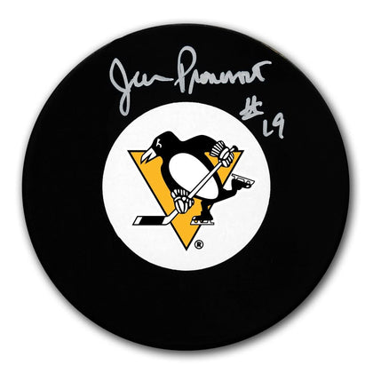 Jean Pronovost signed Pittsburgh Penguins hockey puck, displaying the team logo and a white autograph across the black surface.