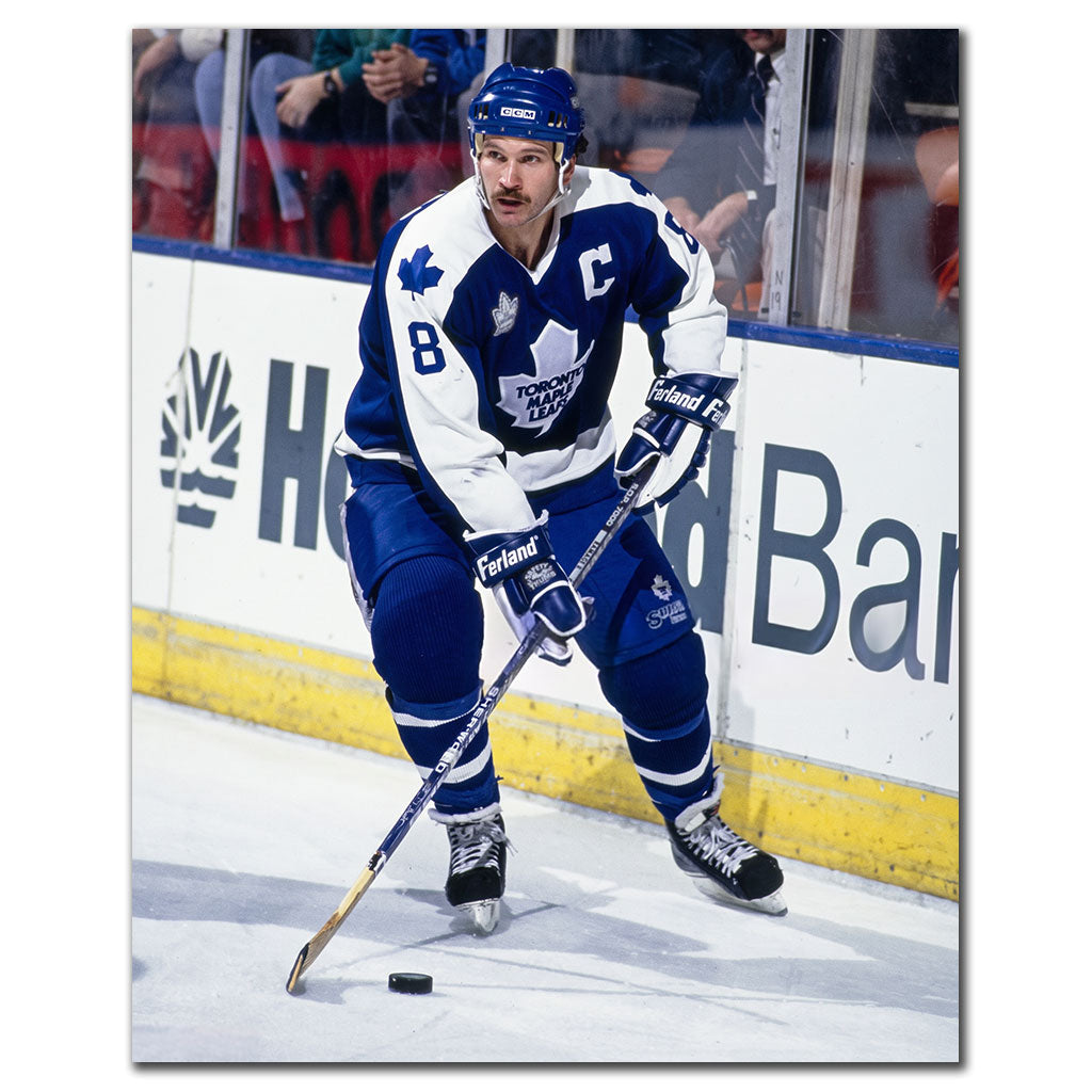 Rob Ramage carrying the puck in a blue Toronto Maple Leafs uniform