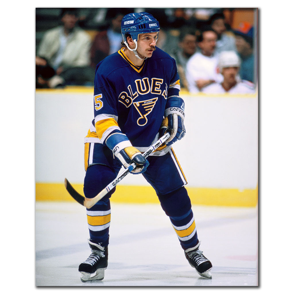 Rob Ramage on the ice in a blue St. Louis Blues uniform