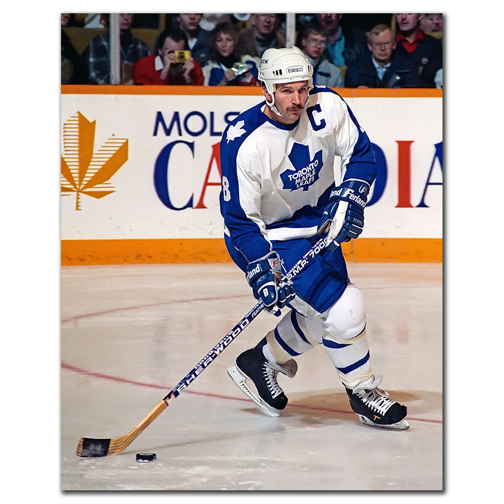 Rob Ramage handling the puck in a white Toronto Maple Leafs uniform