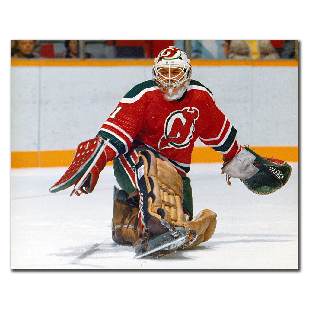 Chico Resch New Jersey Devils 8x10 hockey photo wearing a red jersey and white goalie mask while sliding on his knees with his blocker and catching glove extended for autograph pre-order
