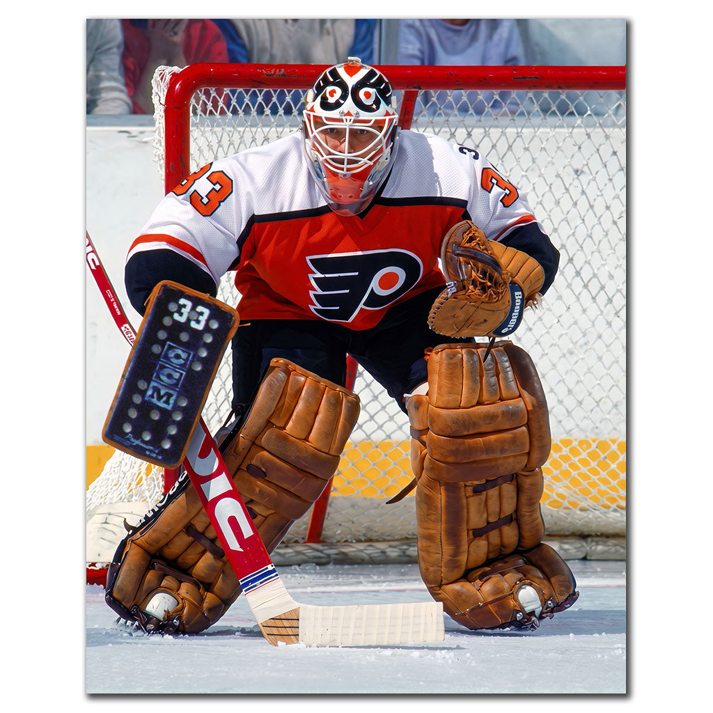 Chico Resch Philadelphia Flyers 8x10 hockey photo wearing an orange, white and black jersey and a white cage mask while crouched in a ready stance in front of the net for autograph pre-order
