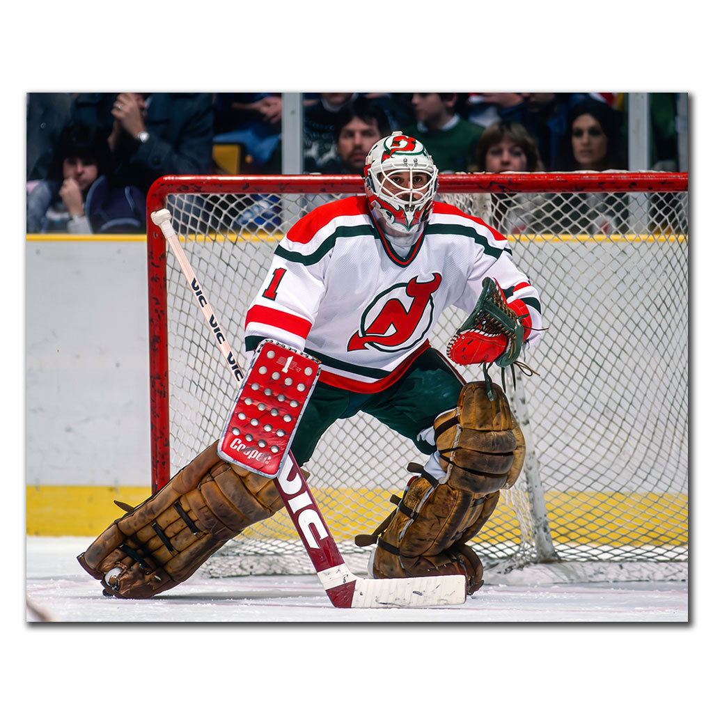 Chico Resch New Jersey Devils 16x20 hockey photo wearing a white jersey with red and green trim and a matching goalie mask while holding a wide ready stance in front of the net for autograph pre-order