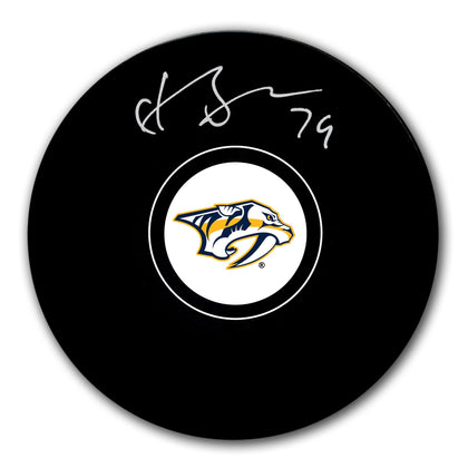 Juuse Saros Nashville Predators Autographed Puck features Saross signature across the official team logo, ideal for collectors.