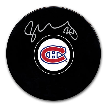 Juraj Slafkovsky signed Montreal Canadiens hockey puck featuring his autograph across the black surface—essential memorabilia for fans.