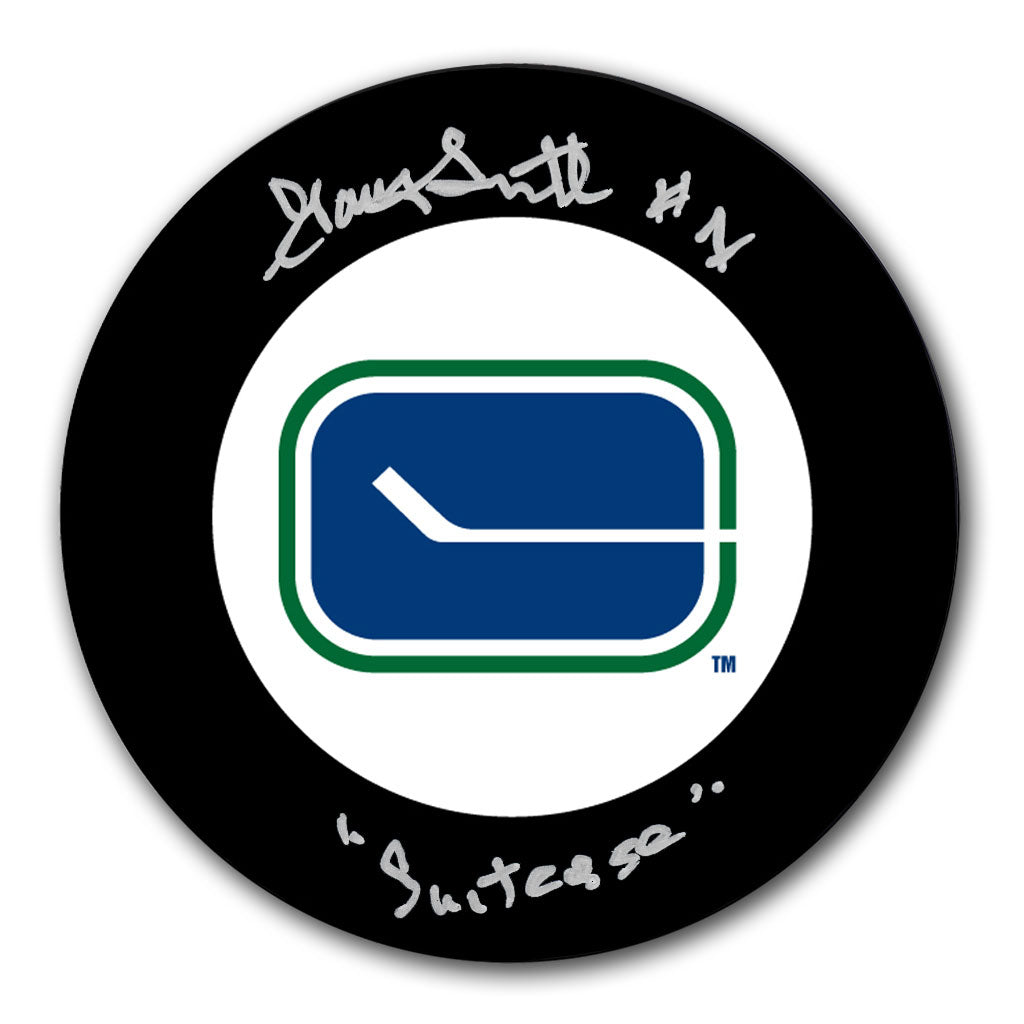 Gary Smith autographed Vancouver Canucks hockey puck with Suitcase inscription and vintage stick-in-rink logo