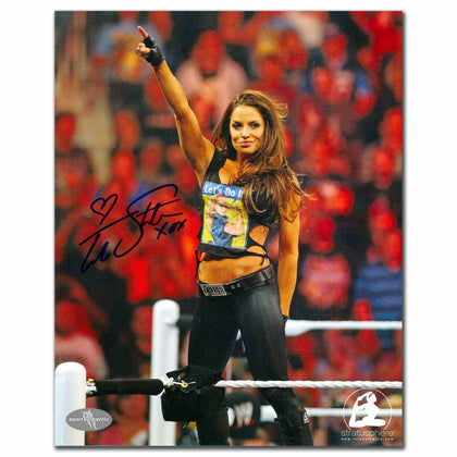 Autographed 8x10 photo of Trish Stratus in wrestling gear, arm raised, signed at WRESTLEMANIA XXVII.