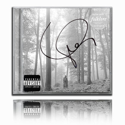Taylor Swift FOLKLORE CD, autographed on the front insert, featuring cover art of a lone figure in a misty forest.