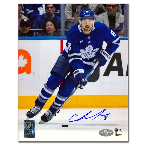 Chris Tanev autographed Toronto Maple Leafs 8x10 photo skating in blue jersey with puck