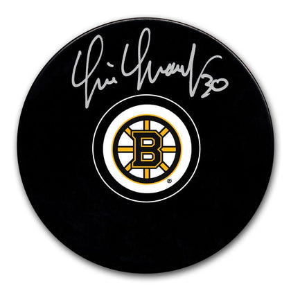 Tim Thomas Boston Bruins signed hockey puck with official team logo and silver autograph on the front, collectible memorabilia.