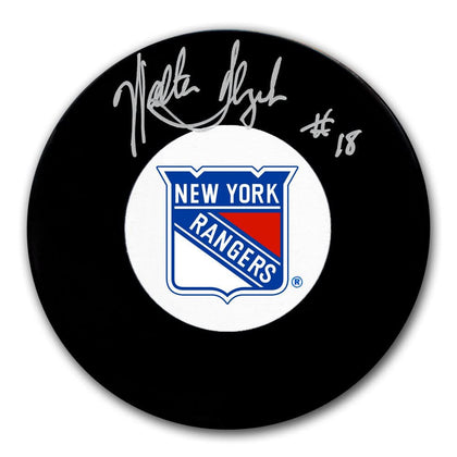 Walt Tkaczuk New York Rangers signed puck—#18 signature in silver ink on an official black hockey puck, collectible format.