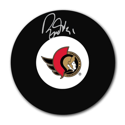 Ron Tugnutt Ottawa Senators signed hockey puck with team logo displayed at the center and a silver autograph across the surface.