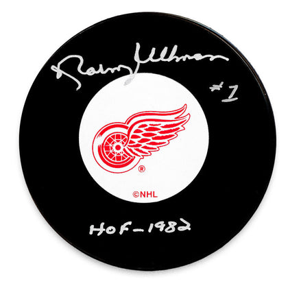 Official Detroit Red Wings hockey puck autographed by HOF player Norm Ullman, ideal for sports memorabilia collections.