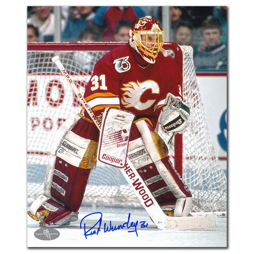 Rick Wamsley autographed Calgary Flames 8x10 photo guarding the crease in a red jersey