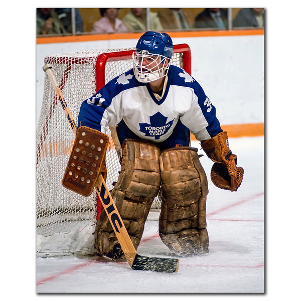 Ken Wregget positioned in front of the net in a white Toronto Maple Leafs uniform