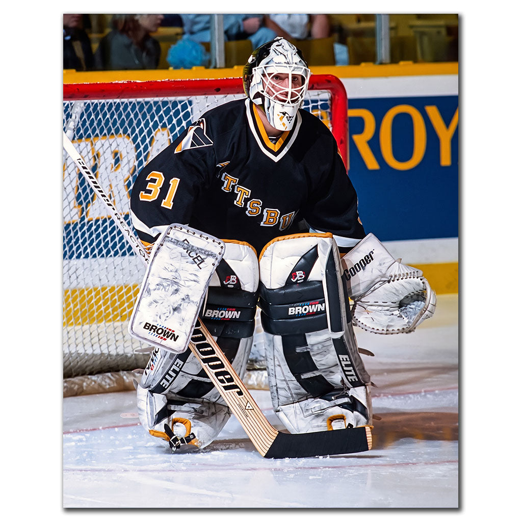 Ken Wregget positioned in front of the net in a black Pittsburgh Penguins uniform
