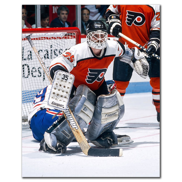 Ken Wregget tending goal in an orange Philadelphia Flyers uniform